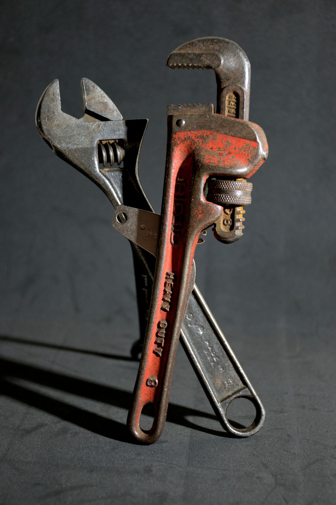 Photo by Ronaldo Guiraldelli from Pexels: A close-up view of vintage wrenches arranged on a textured dark surface.
